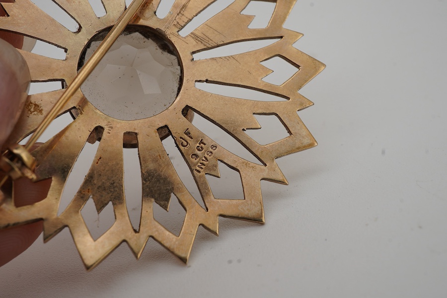 A smoky quartz brooch, set with a circular-cut smoky quartz, within a floral gold surround, 5.7cm diameter, stamped 9CT, maker's mark JF, stamped IVSS, gross weight 17 grams